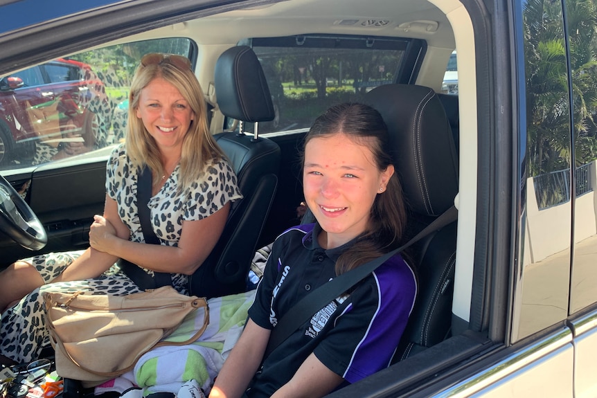 Tilly Stubbings, 11, with her mother in a car outside Broadbeach State School.