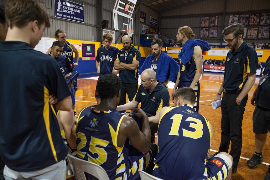 Kalgoorlie's Goldfields Giants basketball team huddles during half time.