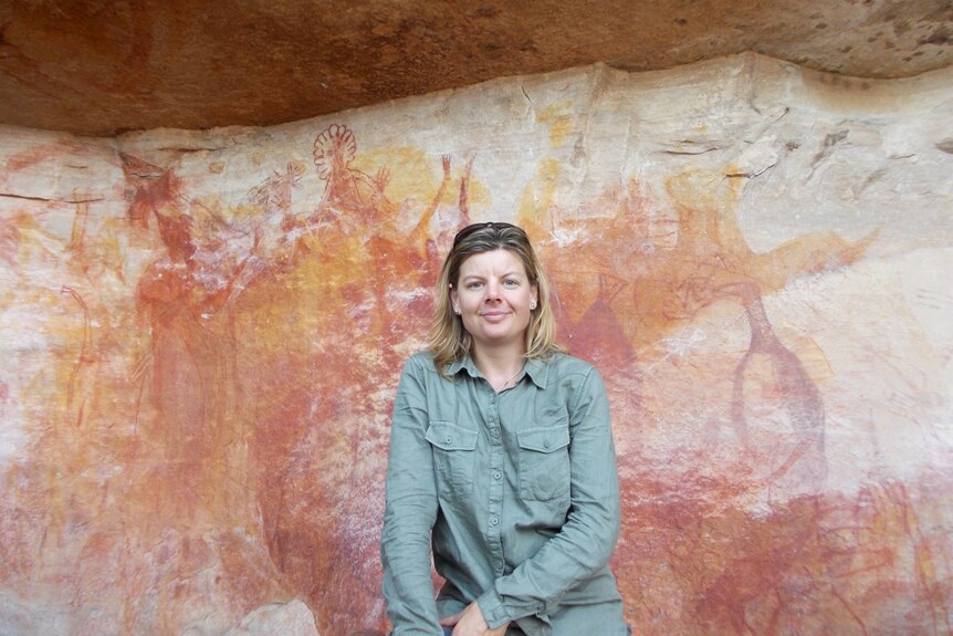 Jane Bardon pictured in front of Indigenous rock paintings.