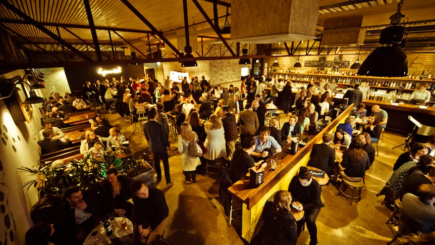 People inside a large bar.