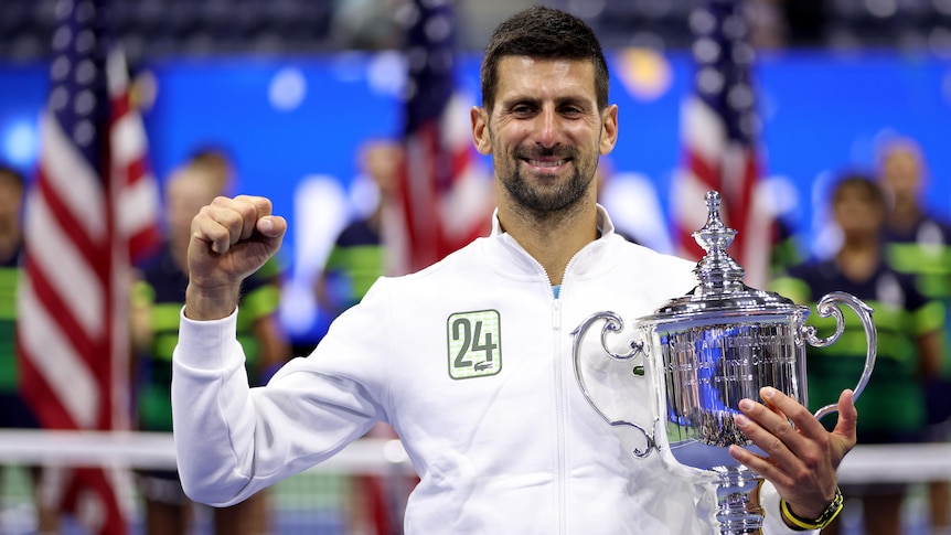 Novak Djokovic holds a silver trophy