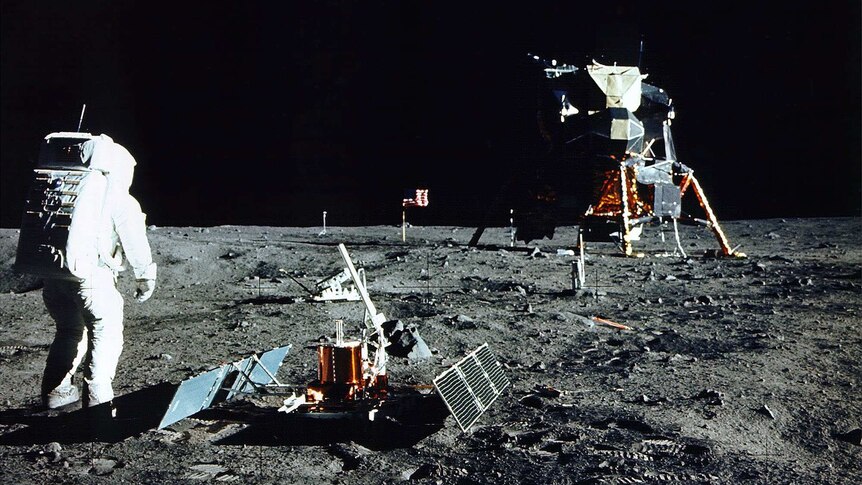 Historic colour photo of astronaut conducting experiment on the Moon's surface.