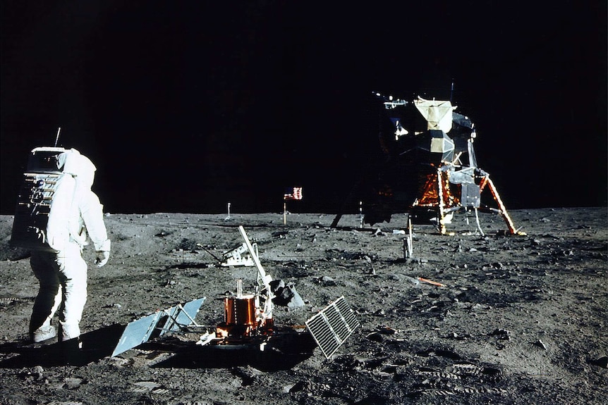 Historic colour photo of astronaut conducting experiment on the Moon's surface.