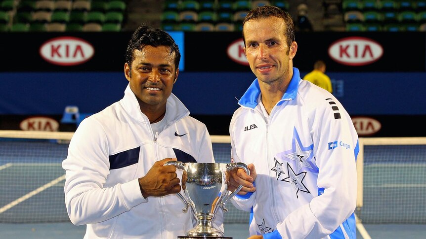 Radek Stepanek (R) and Leander Paes of India pose with the trophy after winning their men's doubles final match.