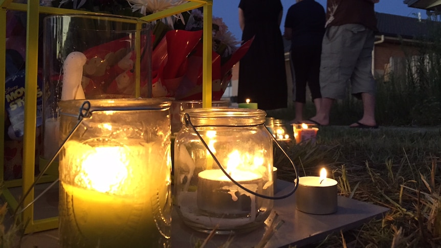 People attend a candle-lit vigil last night for Bradyn Dillon.