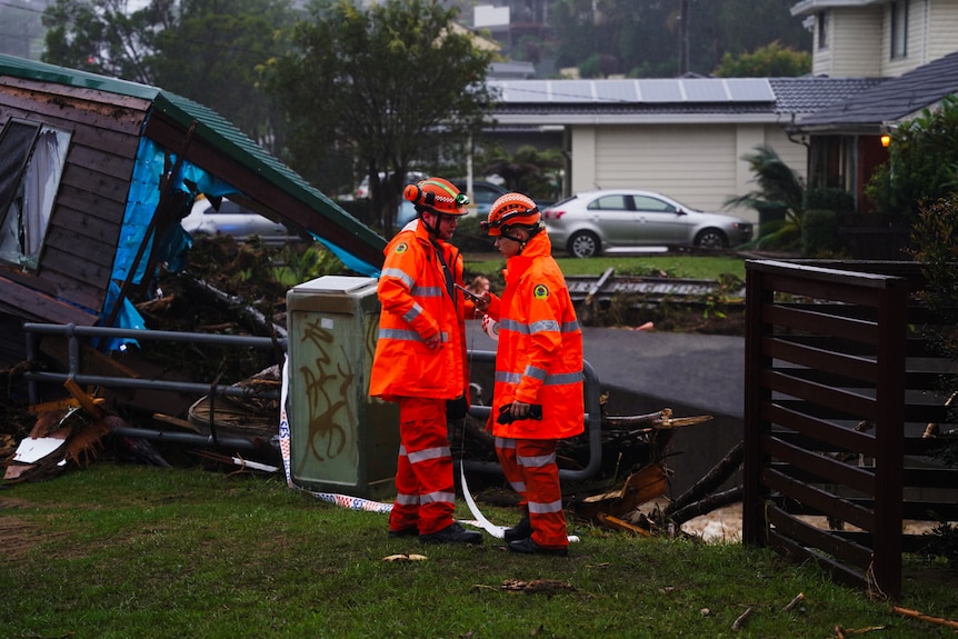 SES workers at the site of a brown clad granny flat washed away.