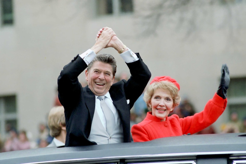 Ronald Reagan and Nancy Regan wave from limousine