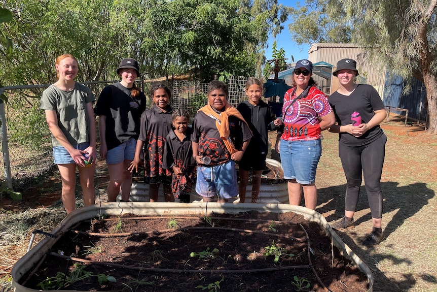 People admiring a newly-built garden bed.