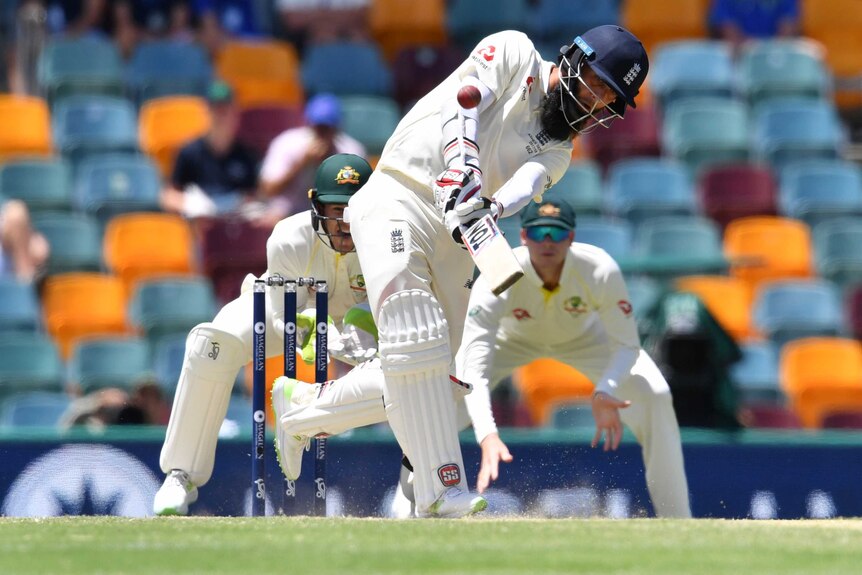 Moeen Ali hits out to the off side from the bowling of Nathan Lyon at the Gabba.