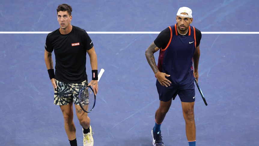Thanasi Kokkinakis and Nick Kyrgios look up at the scoreboard during their doubles match at the US Open.
