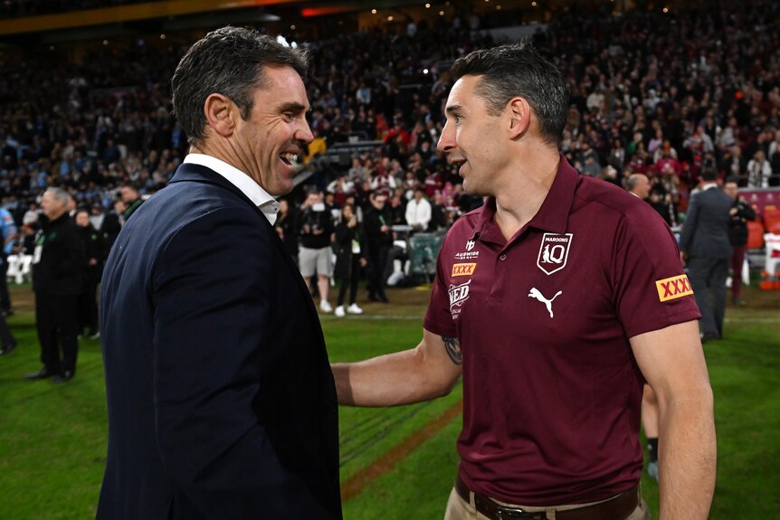 Two coaches speak after a rugby league match