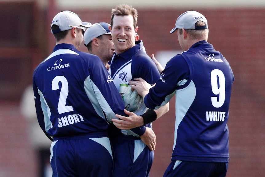 Victoria players congratulate Andrew Fekete after he took a wicket against Tasmania in the one-day cup final.