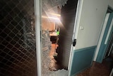 A sliding door that has been smashed.