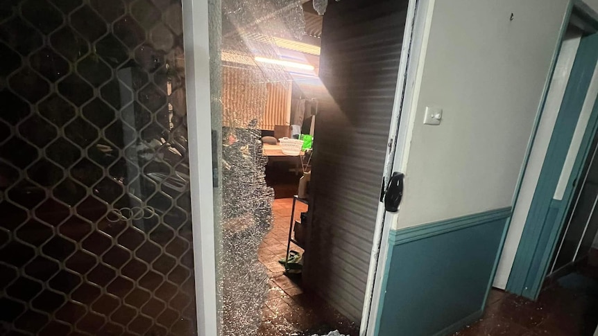 A sliding door that has been smashed.