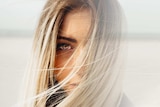 Close up of a woman's face half of it fading to nothing.