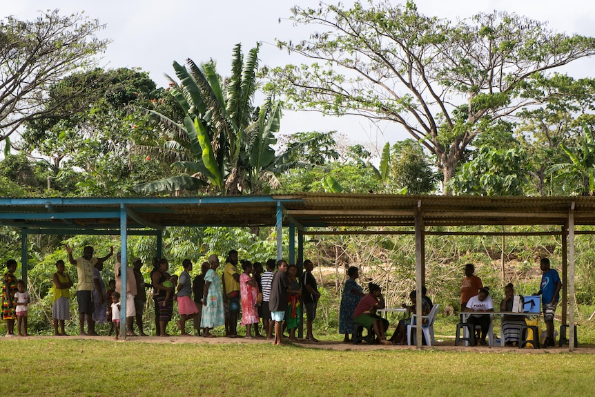 A line of people in Port Vila, Vanuatu.