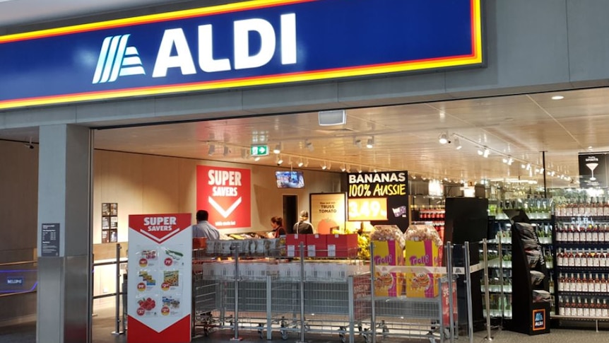 The entrance to a well-lit Aldi supermarket inside a shopping centre.