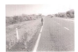 A black and white photograph of an outback road.