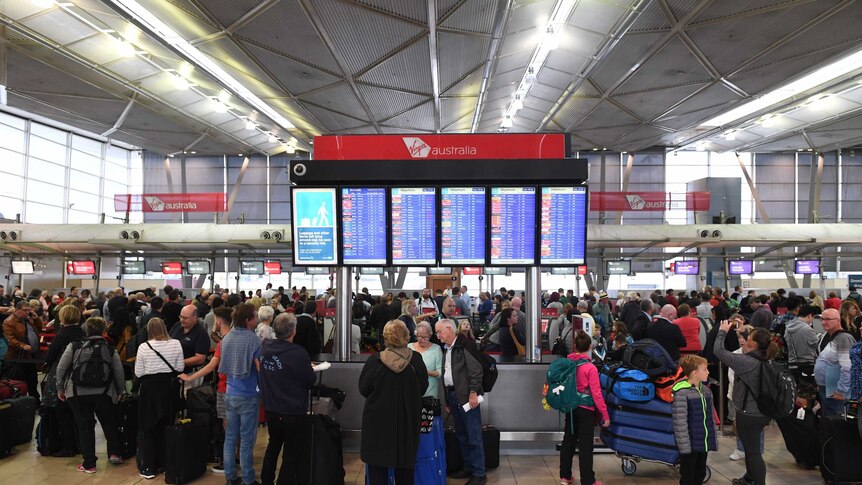 Airline passengers wait to check in at Sydney's T2 Domestic Terminal.