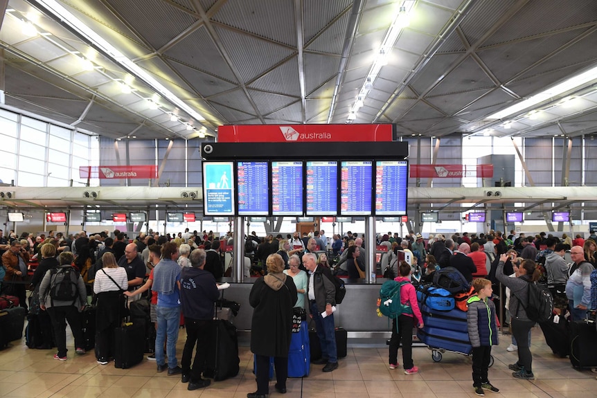 Airline passengers wait to check in at Sydney's T2 Domestic Terminal.