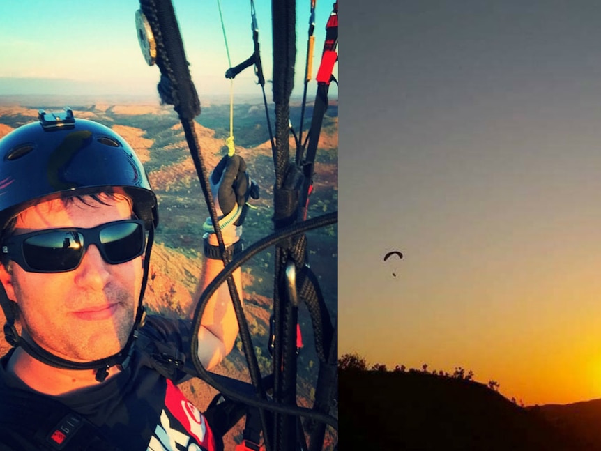 A small paraglider over a landscape of red dirt and spinifex.