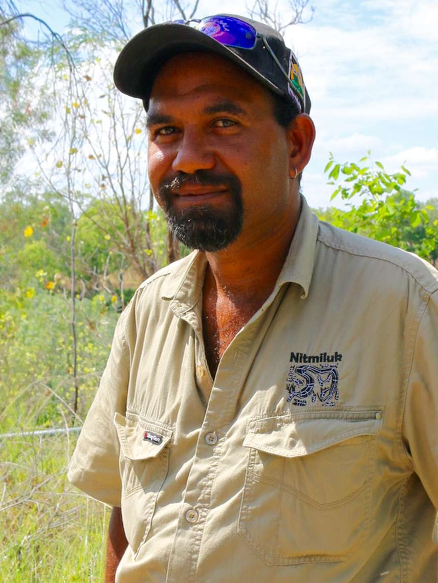 Jamie Brooks wears his tour uniform and a cap and smiles at the camera