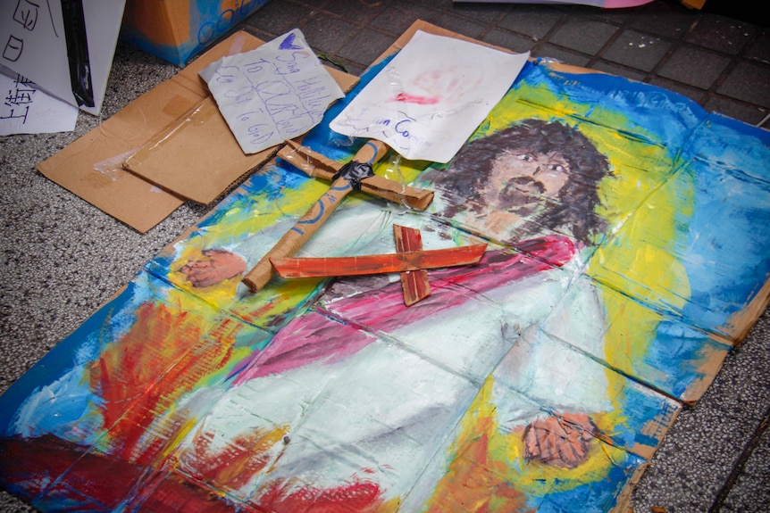 Cartoon drawings of Jesus and a cross on the ground
