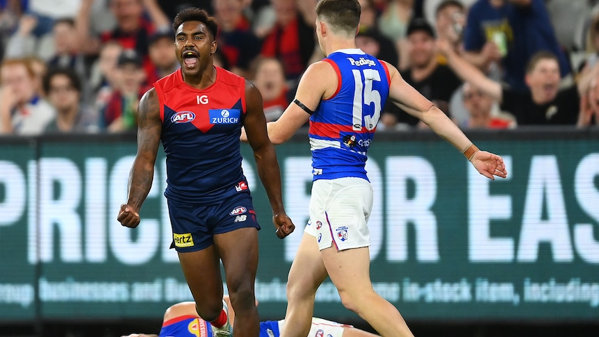 Kysaiah Pickett pumps his fists in delight as Bulldogs players look disappointed behind him