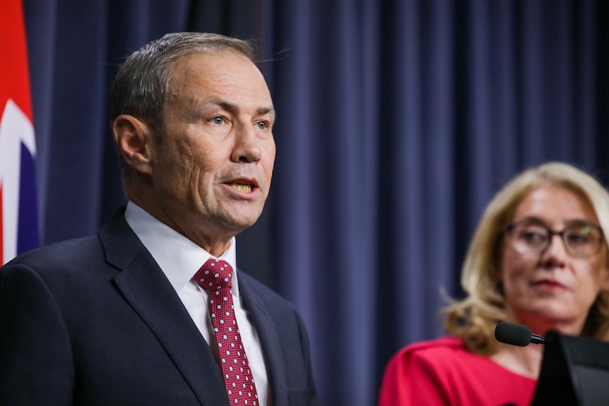 Roger Cook speaks as Rita Saffioti watches on at a press conference