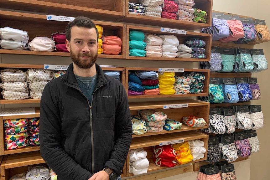 Tom Griffith in front of cloth nappies.