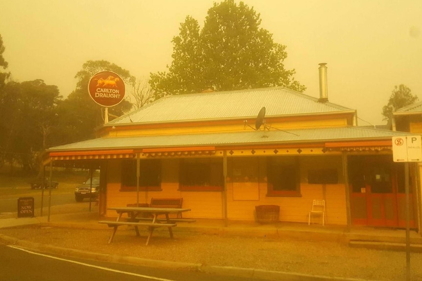 A yellow sky over the Ensay pub which is shrouded in smoke.