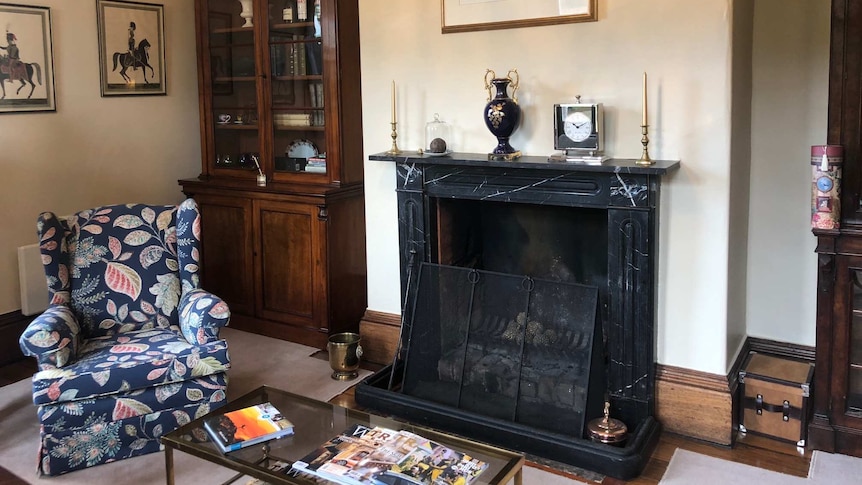 A loungeroom inside Prospect House with original features including a marbled fireplace