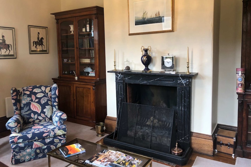 A loungeroom inside Prospect House with original features including a marbled fireplace