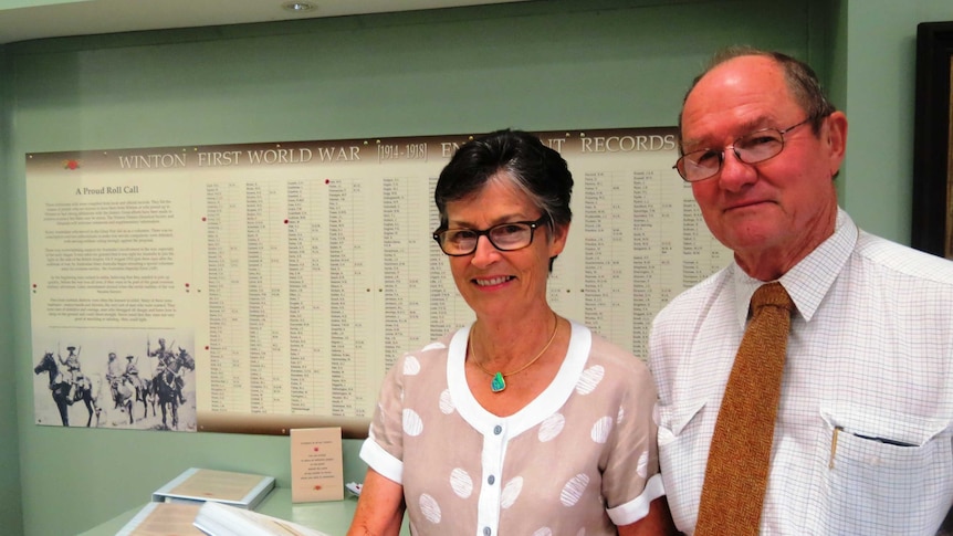 Helen and Bruce Collins look over an exhibit from an Anzac exhibition being held in Winton