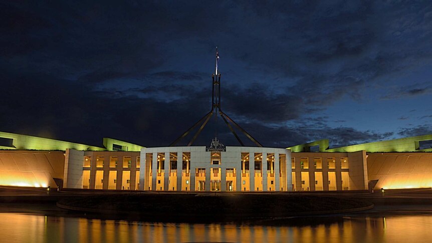 Parliament House in Canberra, photographed from afar at night.