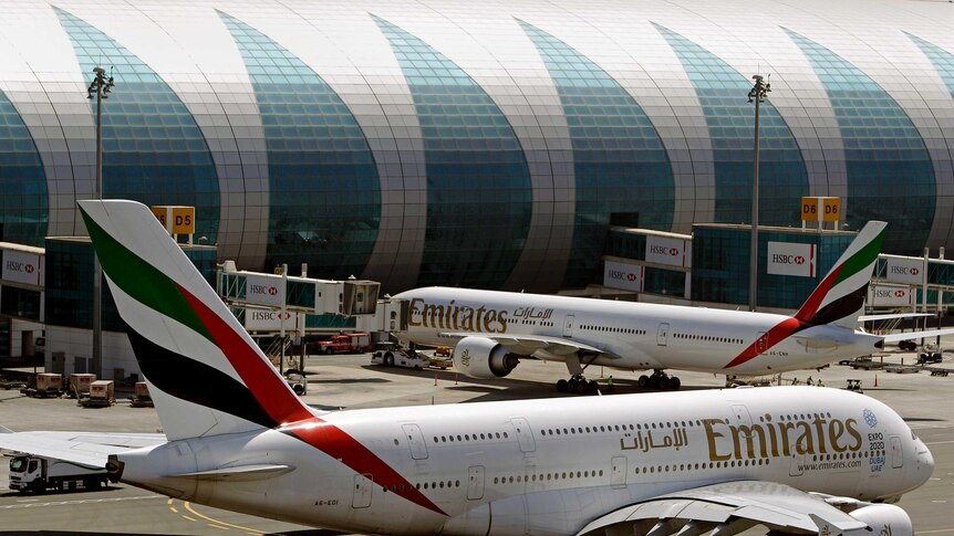 Two passenger jets at Dubai airport.