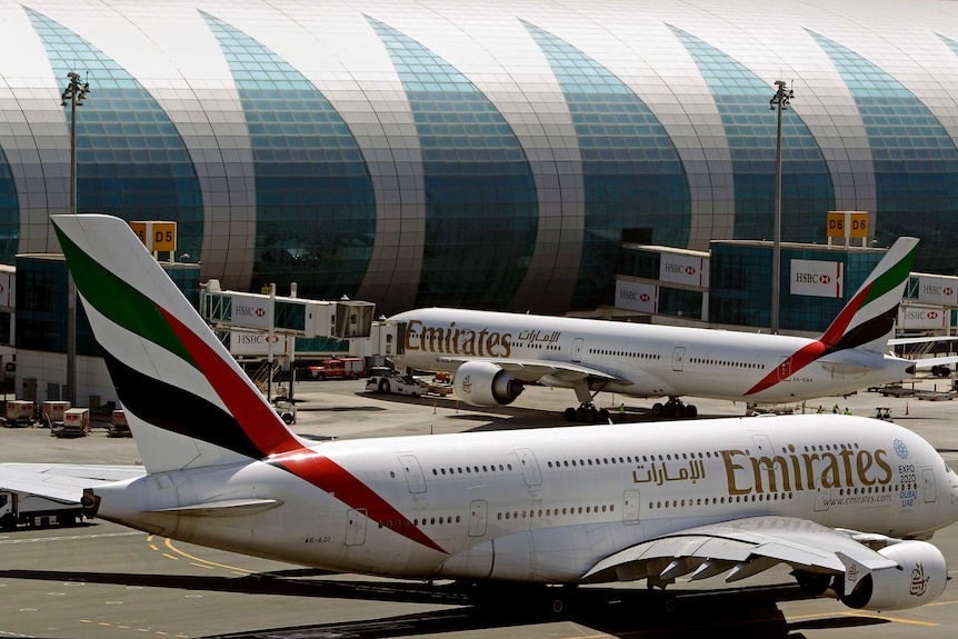 Two passenger jets at Dubai airport.