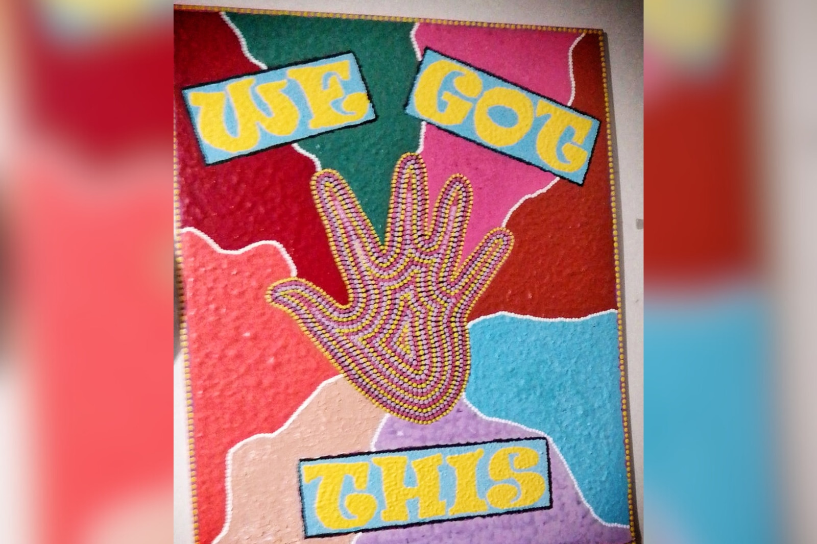 A painted canvas with a handprint and the words ' we got this'.