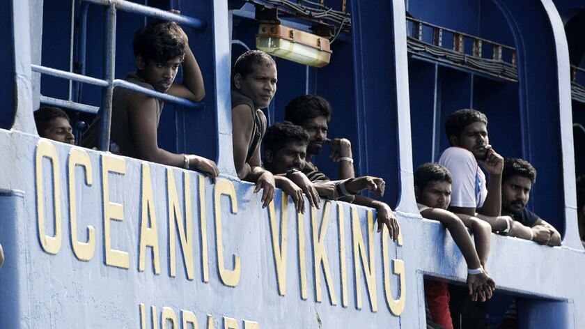 Sri Lankan refugees look out from the Australian coast guard vessel Oceanic Viking