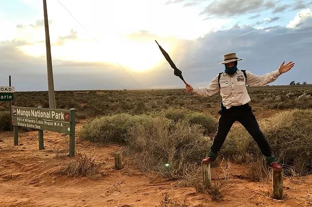 Phil McDonald standing on wood stumps at Mungo National Park.