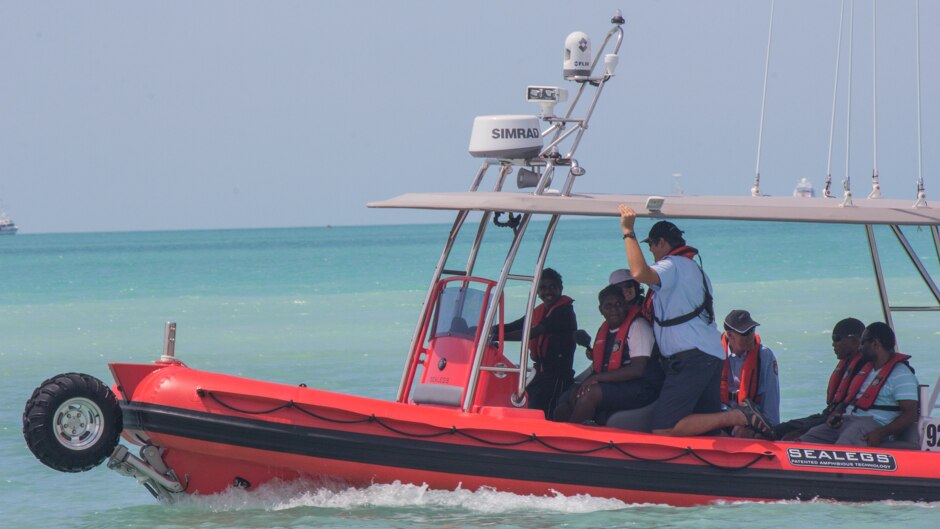 An Aboriginal teenage boy from the desert community of Balgo Hills takes the wheel of the Broome sea rescue boat.