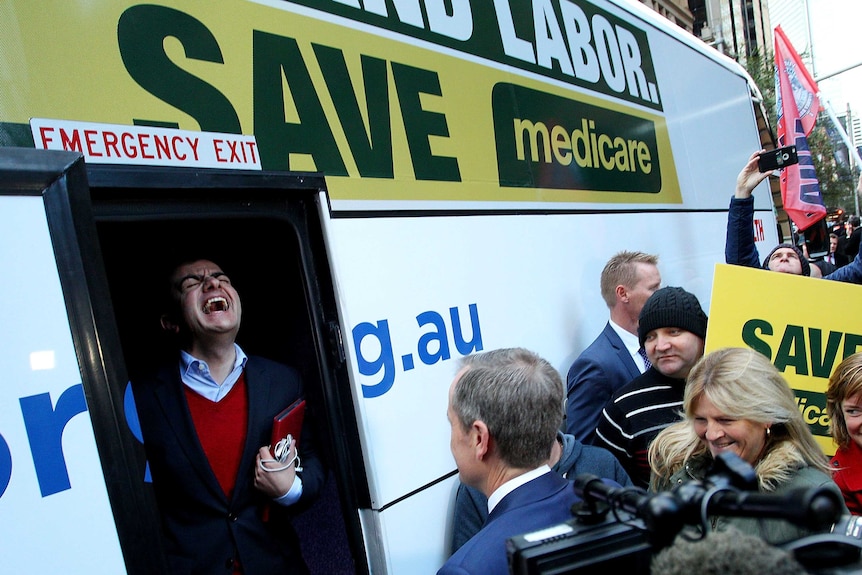 Sam Dastyari laughs as Bill Shorten prepares to board the campaign bus following a Medicare rally in Sydney in 2016