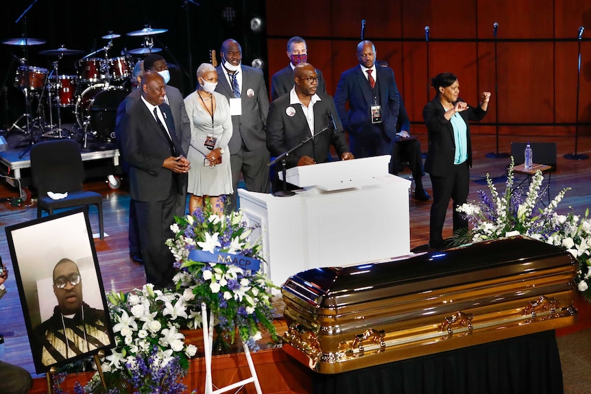 Philonise Floyd stands at a lecturn and speaks at his brother George Floyd's memorial