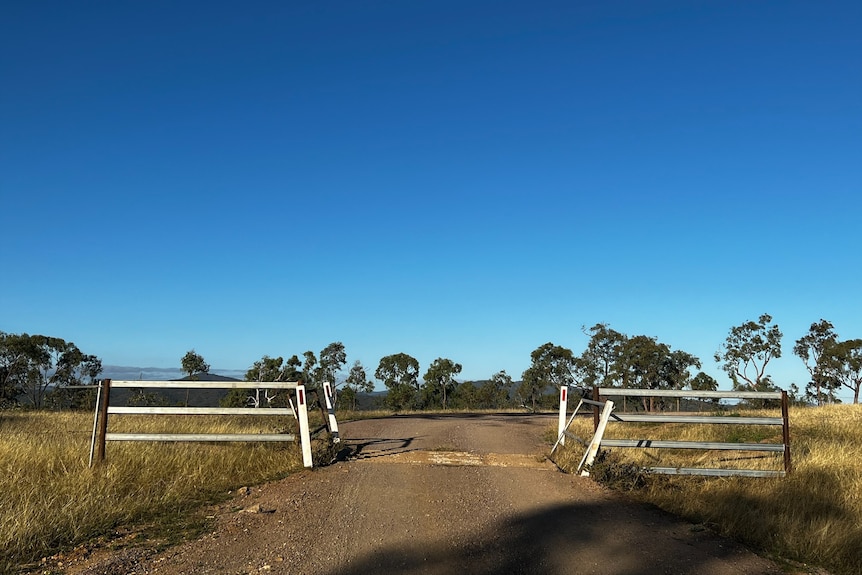 A gate on a dirt road.