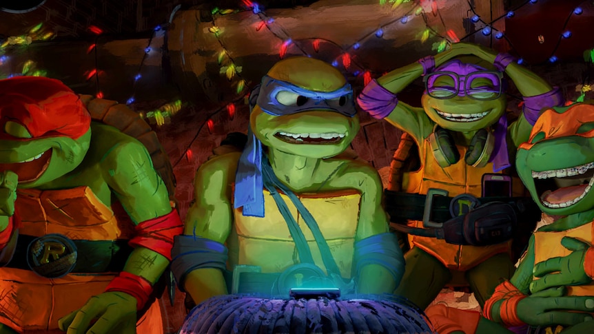 A film still showing four green cartoon turtles each wearing different coloured fabric masks