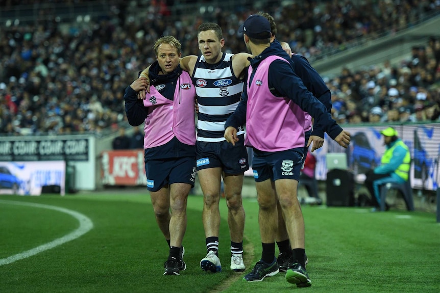 Geelong's Joel Selwood (2L) is carried from the ground after sustaining an injury against Sydney.