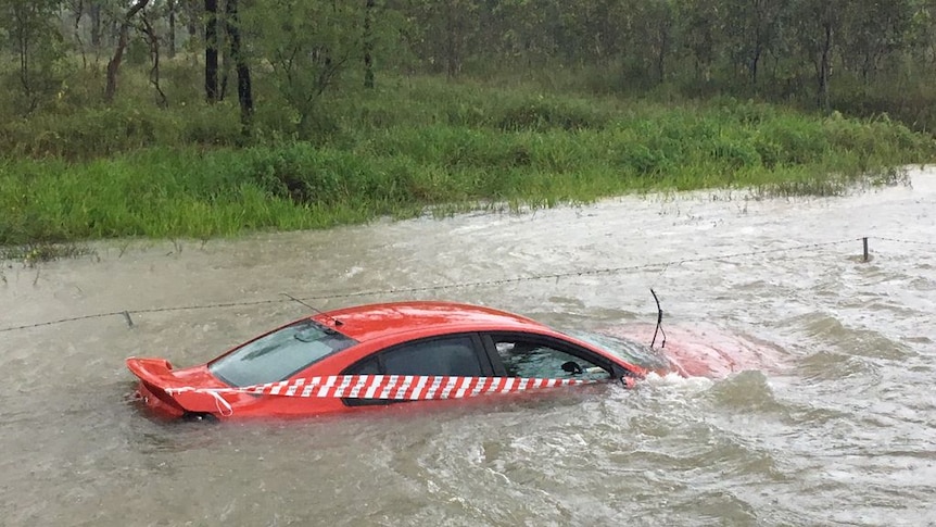 Car sits abandoned in floodwaters near Townsville on March 1