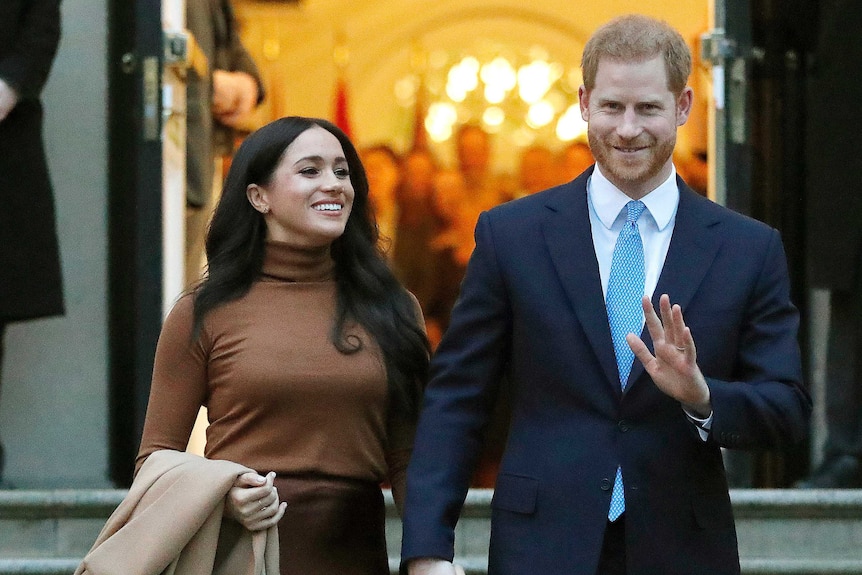Meghan and Harry, the Duke and Duchess of Sussex walk arm in arm
