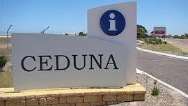 A sign pointing to Ceduna, with a road visible in the background