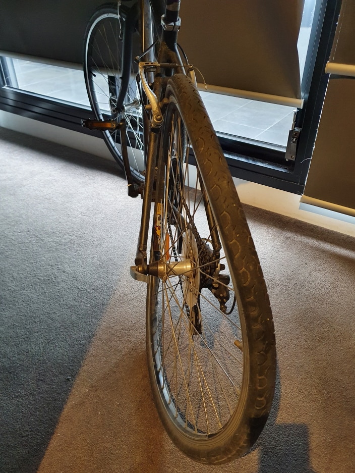 A bike with a bent front wheel.